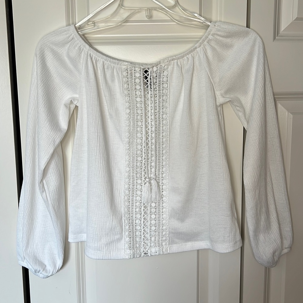 A beautiful white off the shoulder top. A see through shirt but flattering